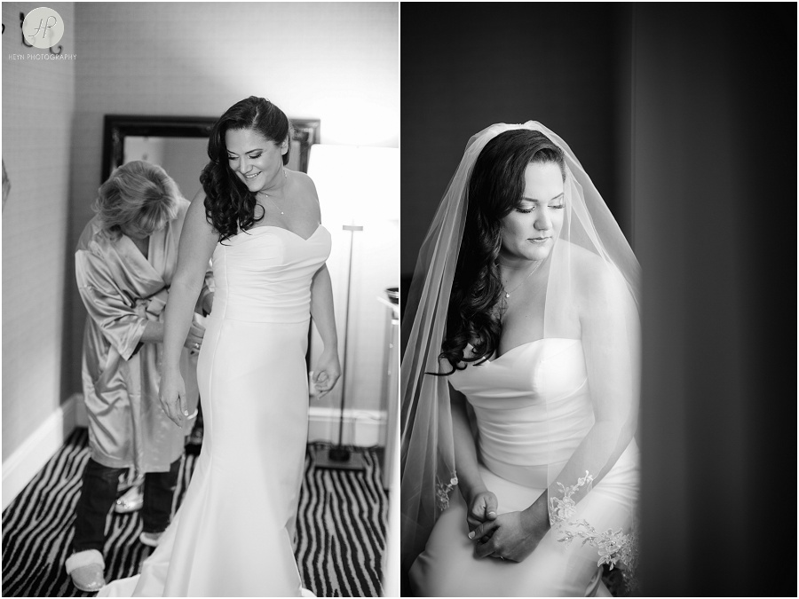 bride gets into wedding dress at the berkeley hotel in asbury park new jersey 