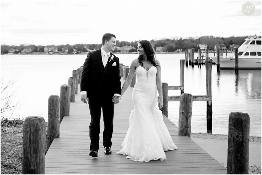 bride and groom walking on dock at clarks landing yacht club wedding
