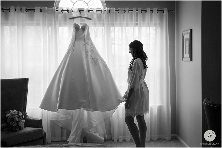 black and white bride looking at dress at clarks landing yacht club wedding