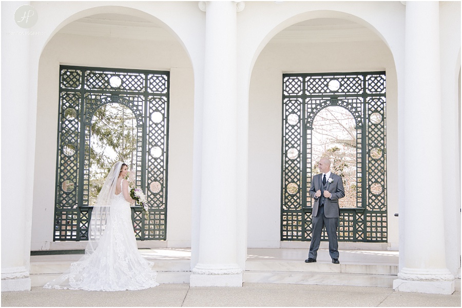 bride and groom posing outside Monmouth University Library wedding