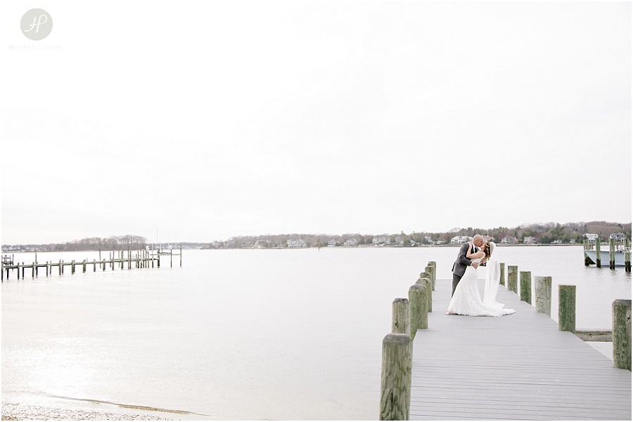 bride and groom kissing on dock at clarks landing yacht club in point pleasant nj