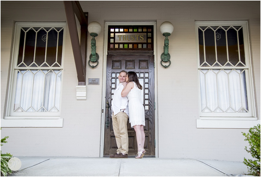Couple kissing at train station in Spring Lake engagement session