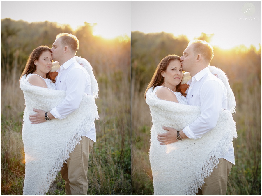 Couple at sunset by beach at Spring Lake engagement session