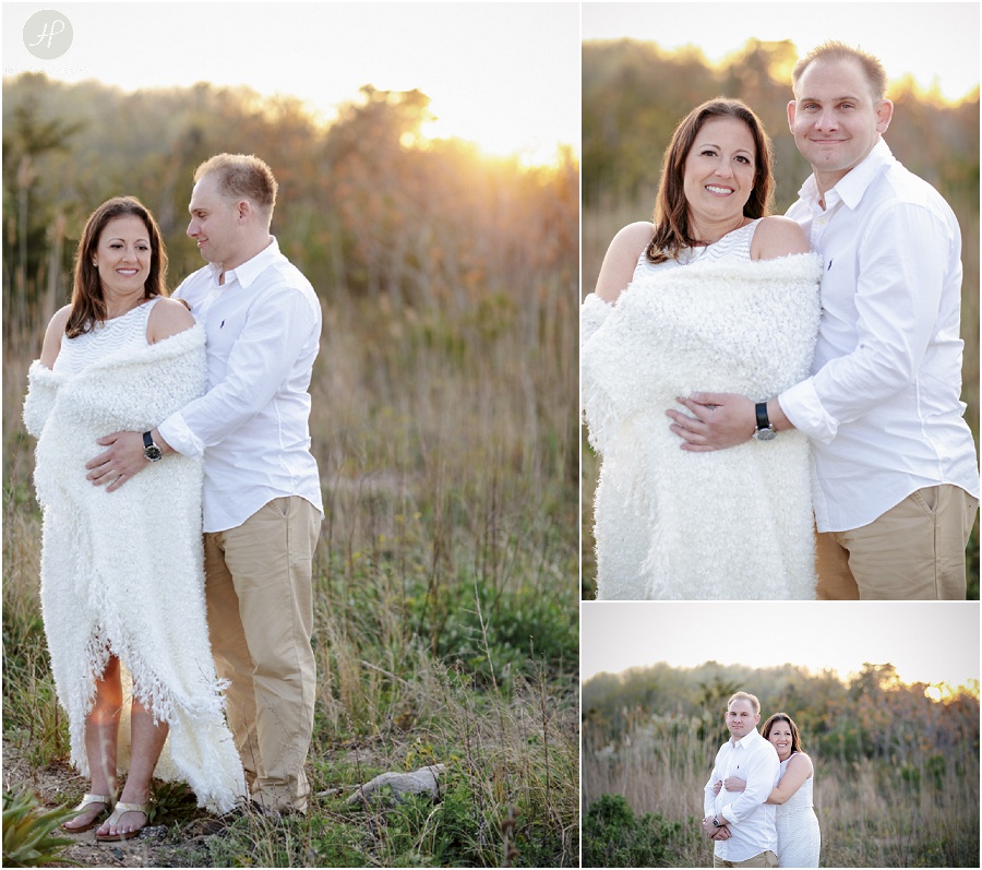 Couple at sunset by beach at Spring Lake engagement session