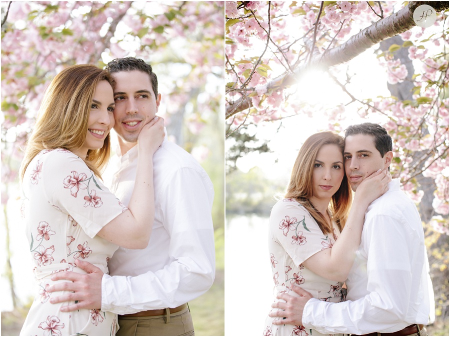 couple by cherry blossom tree at spring lake engagement session in new jersey 