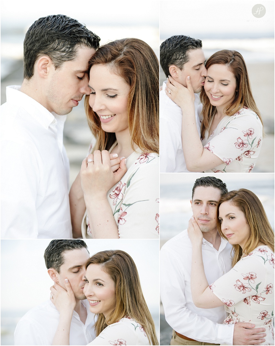 couple cuddling on beach at spring lake engagement session in new jersey 