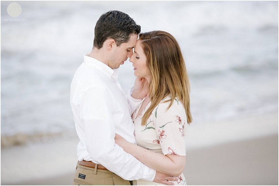 couple close on beach at spring lake engagement session in new jersey 