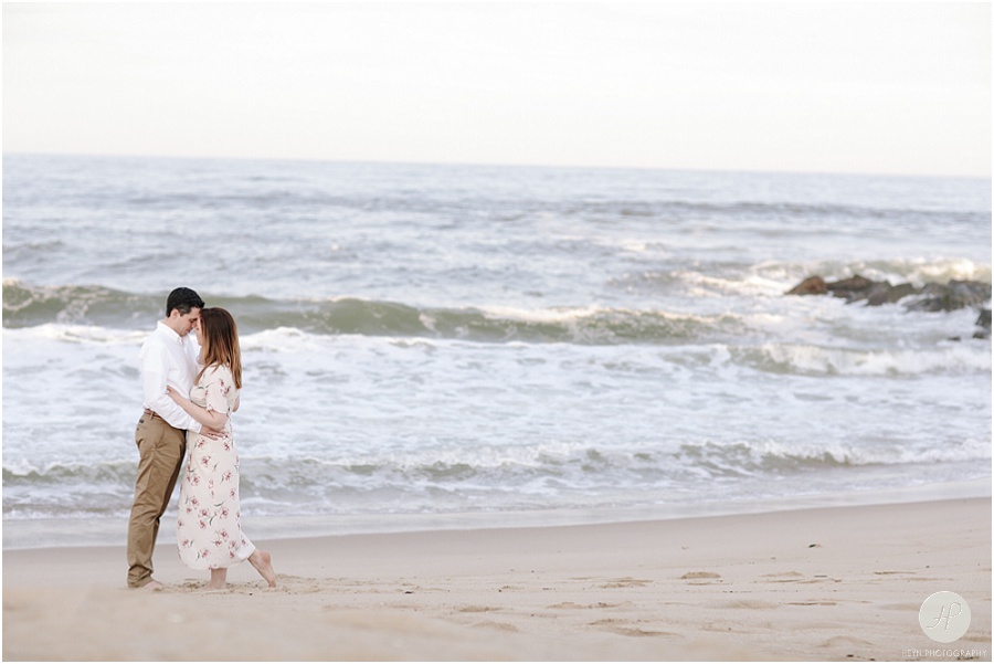  couple kissing on beach at spring lake engagement session in new jersey 