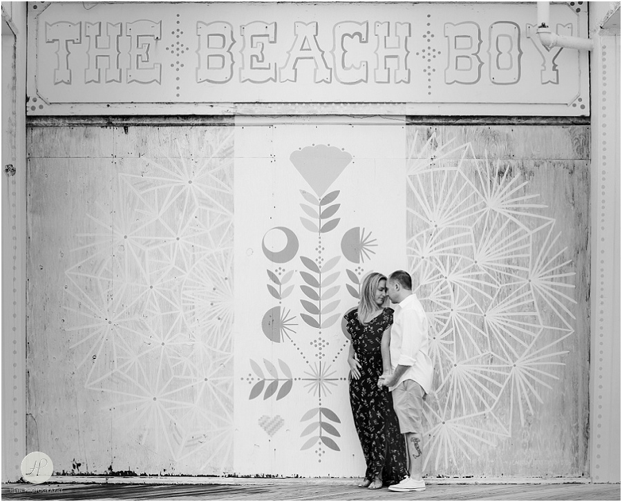 black and white of couple by mural in Asbury Park engagement session jersey shore 