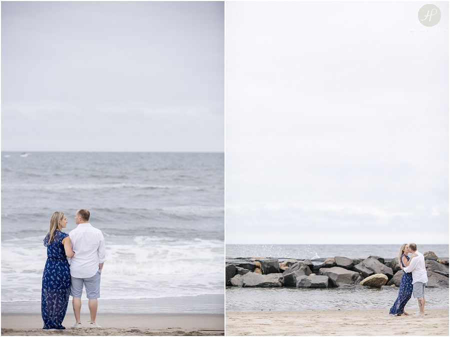  couple walking on beach looking at ocean in Asbury Park engagement session jersey shore 