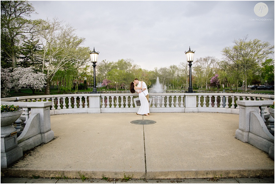 couple kissing by pond in park in downtown westfield engagement session new jersey