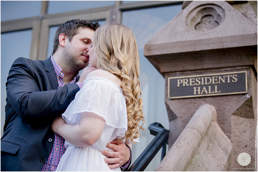 couple kissing by presidents hall at seton hall university engagement session