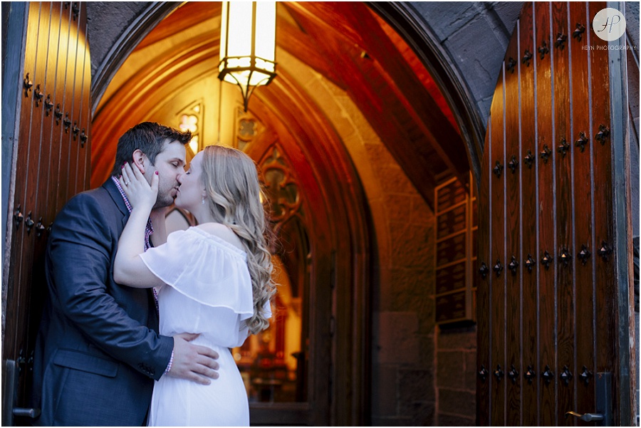 couple kissing in front of chapel at seton hall university engagement session