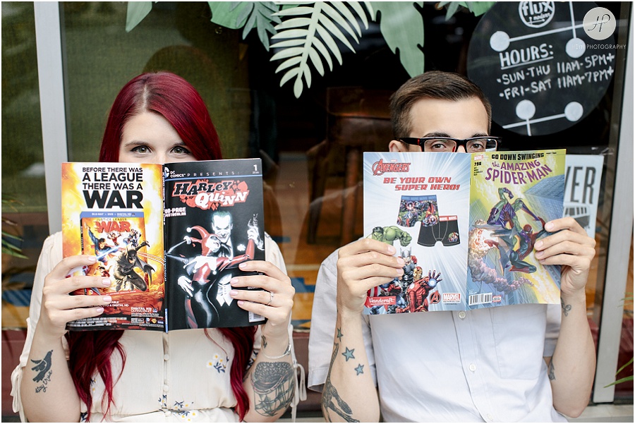 engaged couple reading comic books at downtown asbury park engagement session 
