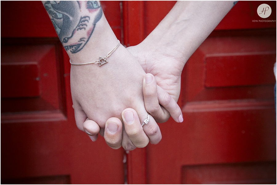 engaged couple holding hands at downtown asbury park engagement session 