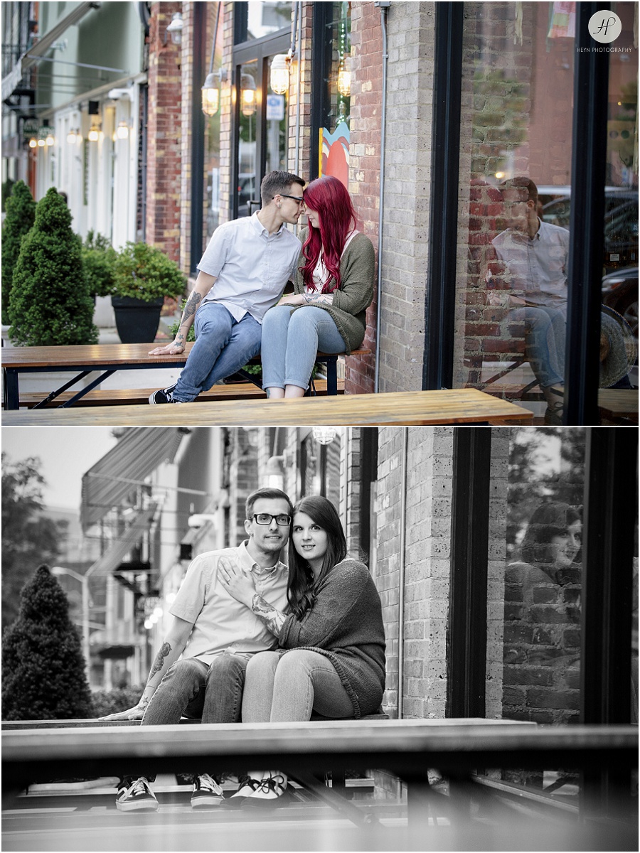 engaged couple kissing in front of cafe at downtown asbury park engagement session 