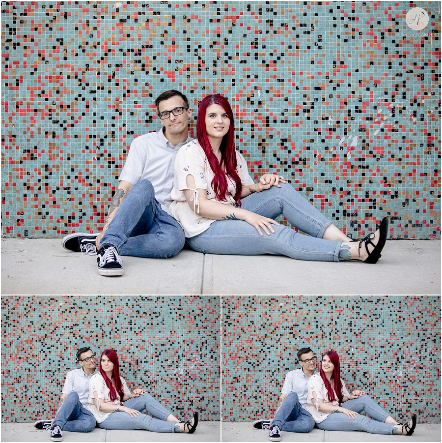 engaged couple kissing in front of colorful mural at downtown asbury park engagement session 