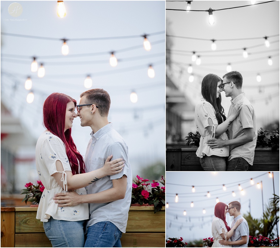 engaged couple kissing in front of lights at downtown asbury park engagement session 