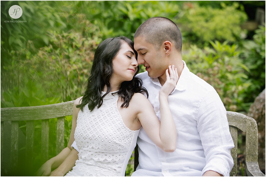engaged couple on bench at sayen gardens new jersey shoot 