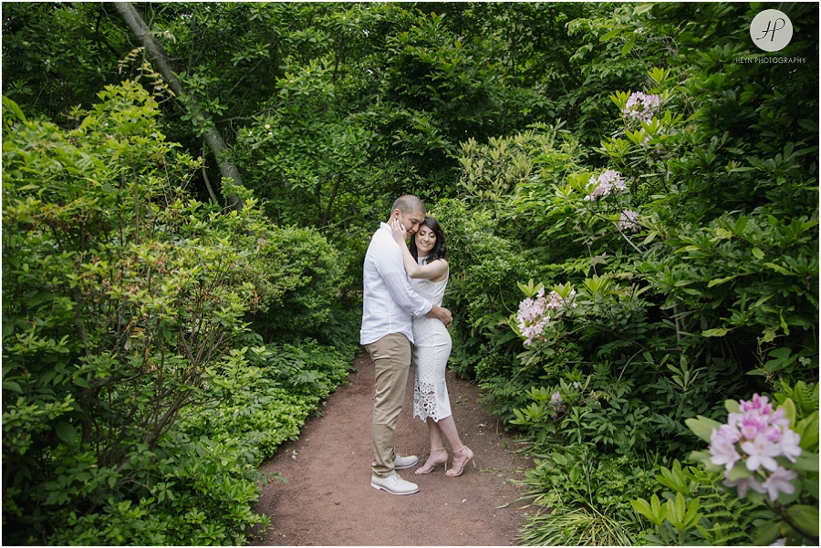 engaged couple on floral path at sayen gardens new jersey shoot 
