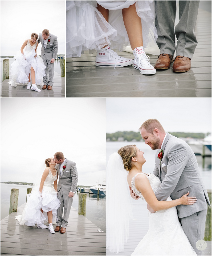 bride and groom on dock in the rain at clarks landing yacht club wedding 