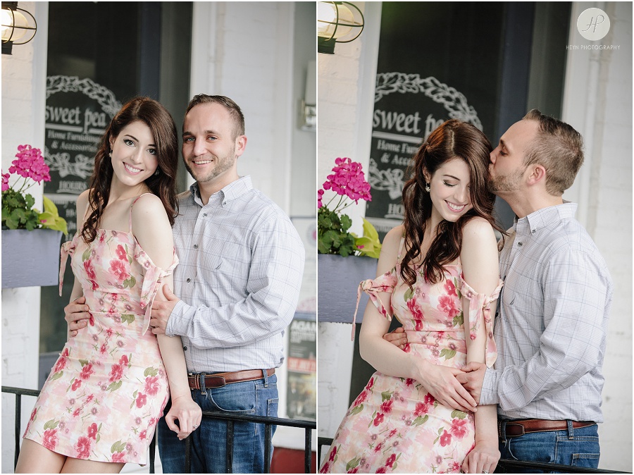 engaged couple in front of store in downtown spring lake engagement session