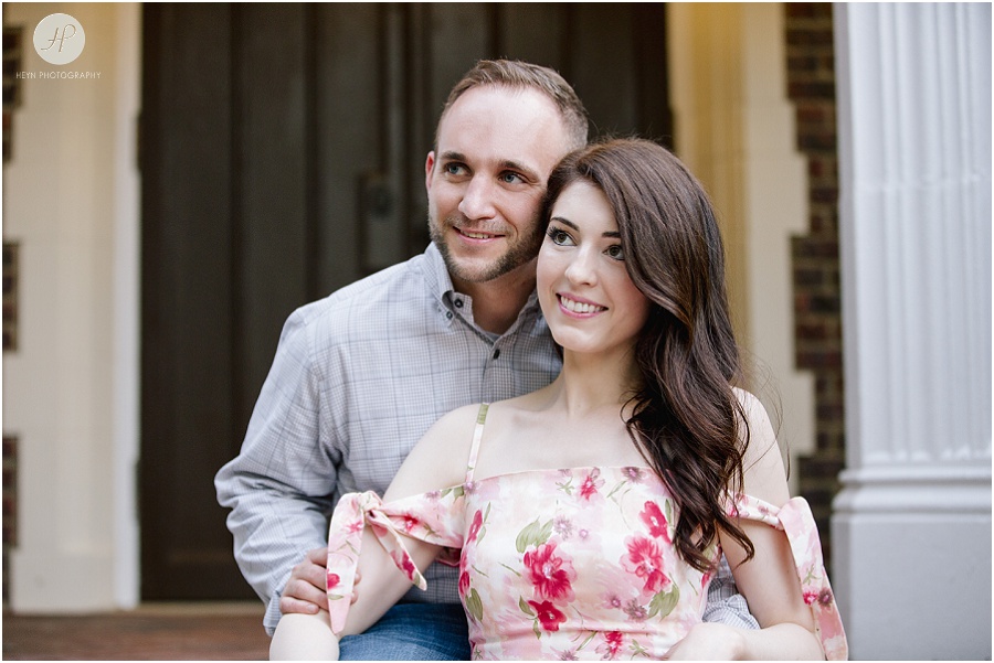 engaged couple sitting on steps in downtown spring lake engagement session