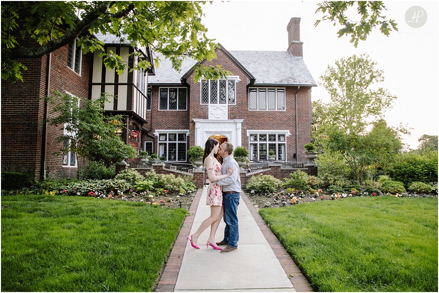  engaged couple kissing in front of brick building in downtown spring lake engagement session