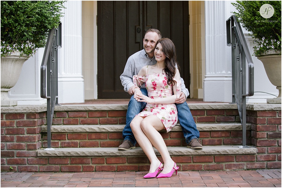  engaged couple sitting on steps in downtown spring lake engagement session
