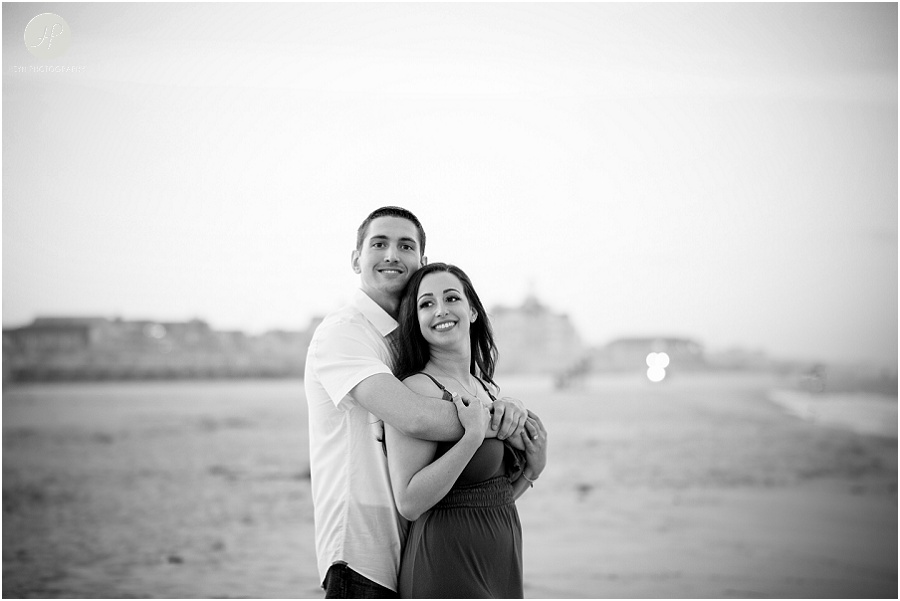 black and white of engaged couple on beach in spring lake engagement session