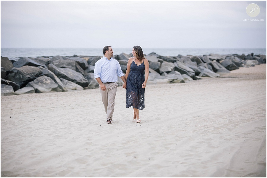 couple waking on beach at asbury park engagement session 