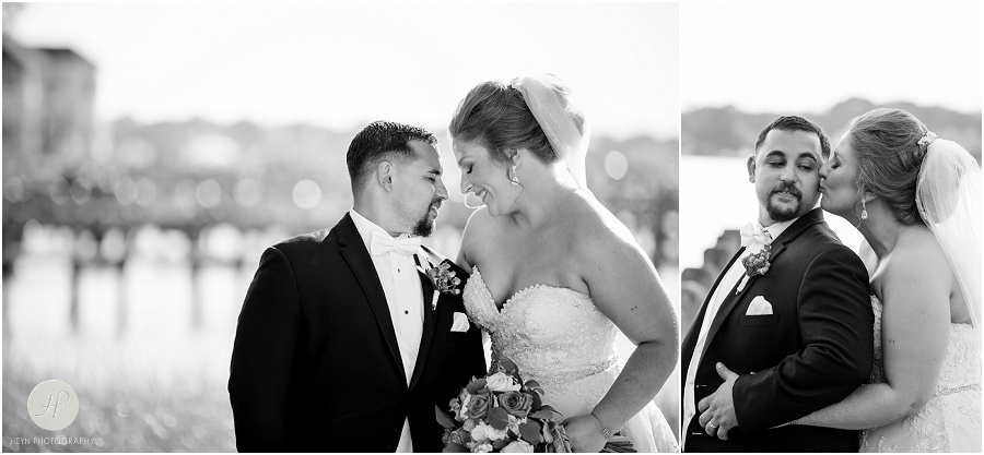 black and white of bride and groom on dock at clarks landing yacht club