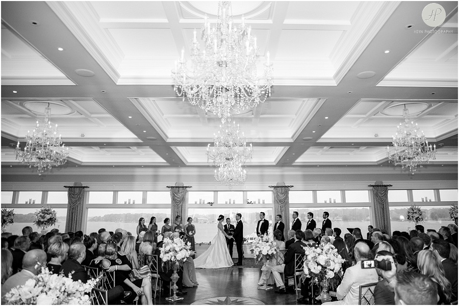 black and white of wedding ceremony in ballroom at clarks landing yacht club 