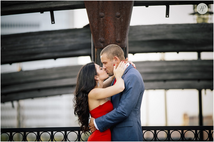 couple by old bridge in liberty state park engagement session jersey city