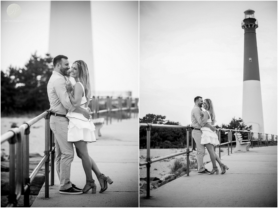 black and white of engaged couple by lighthouse on long beach island engagement session