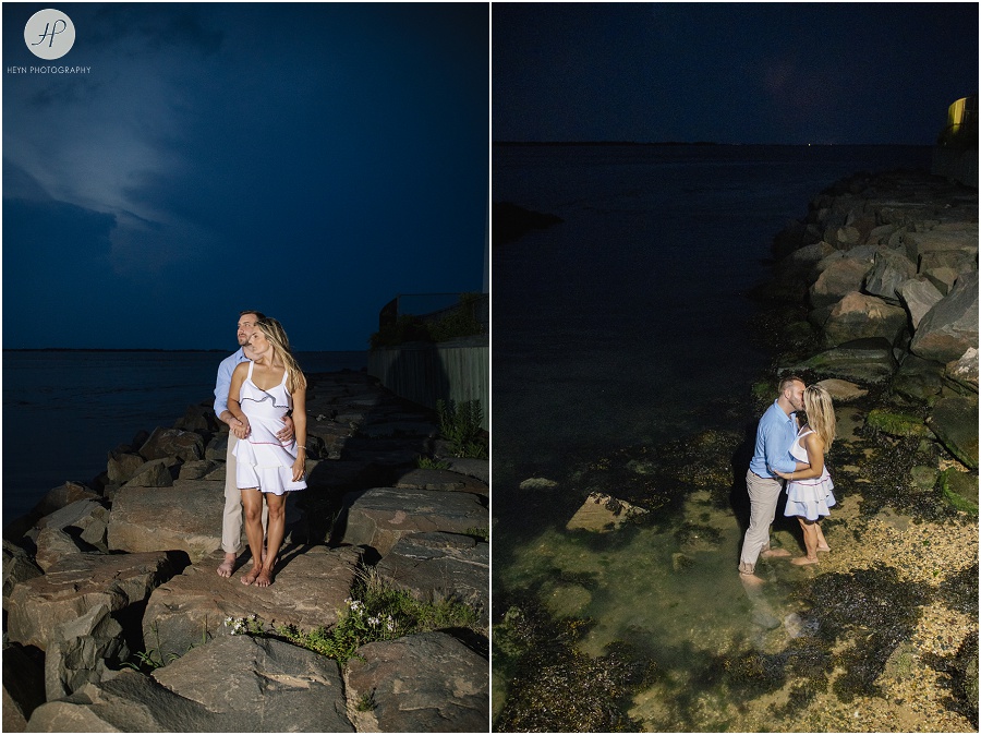  engaged couple in on jetty at night on long beach island engagement session