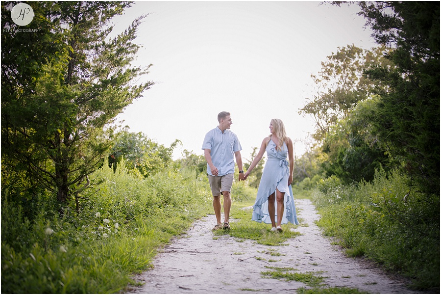 couple walking near beach at manasquan engagement session 