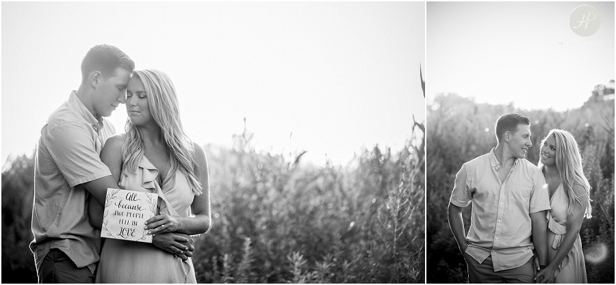 black and white of couple in grass near beach at manasquan engagement session 