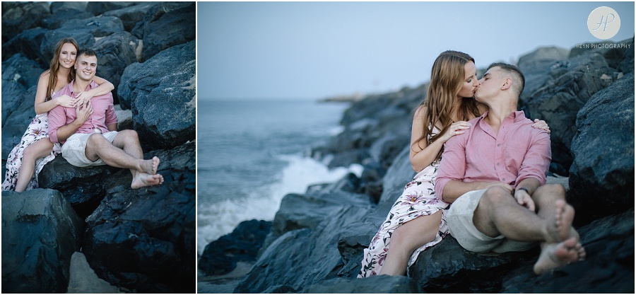engaged couple on jetty on manasquan beach engagement 
