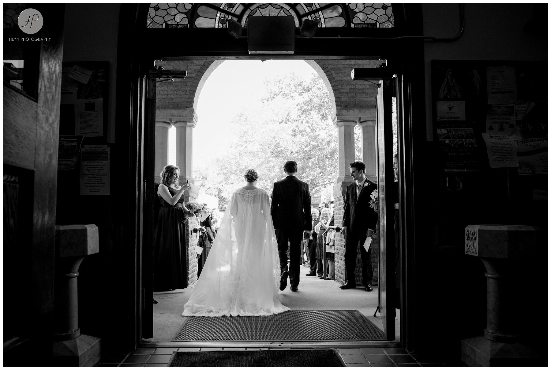 black and white of bride and groom leaving church before molly pitcher inn wedding in new jersey 
