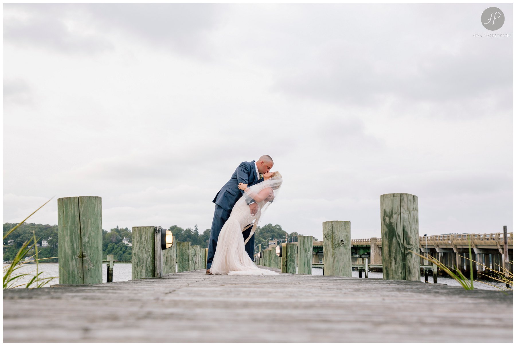 bride and groom kissing on dock before salt creek grille wedding in new jersey 