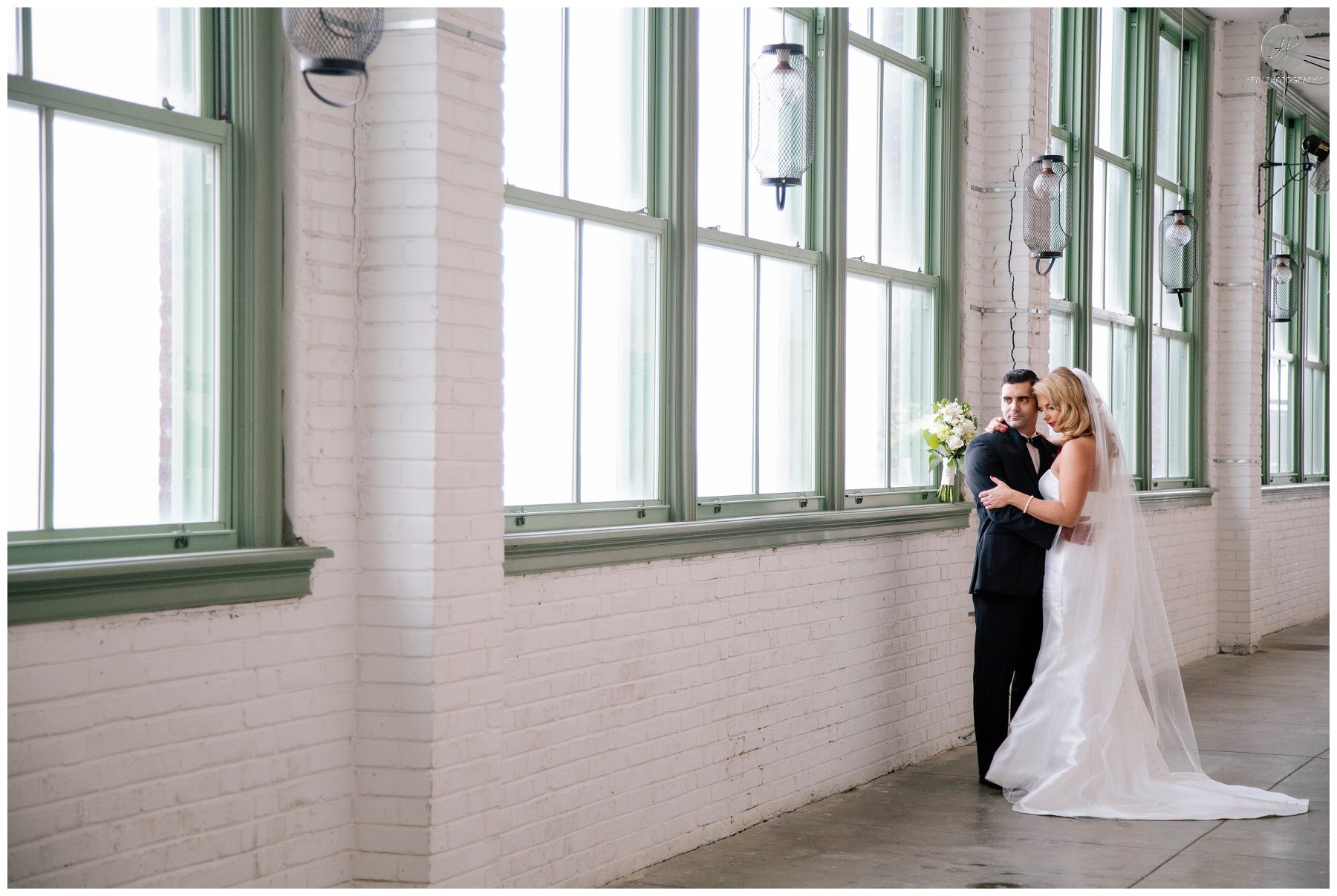 bride and groom in conventional hall in asbury park for spring lake bath and tennis club wedding in new jersey