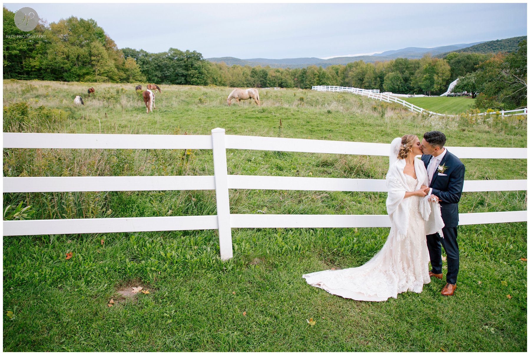bride and groom with horses at stone tavern farm wedding in the catskills new york