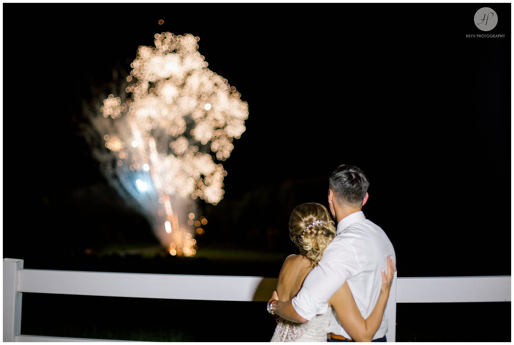 bride and groom watching fireworks at barn reception at stone tavern farm wedding in the catskills new york