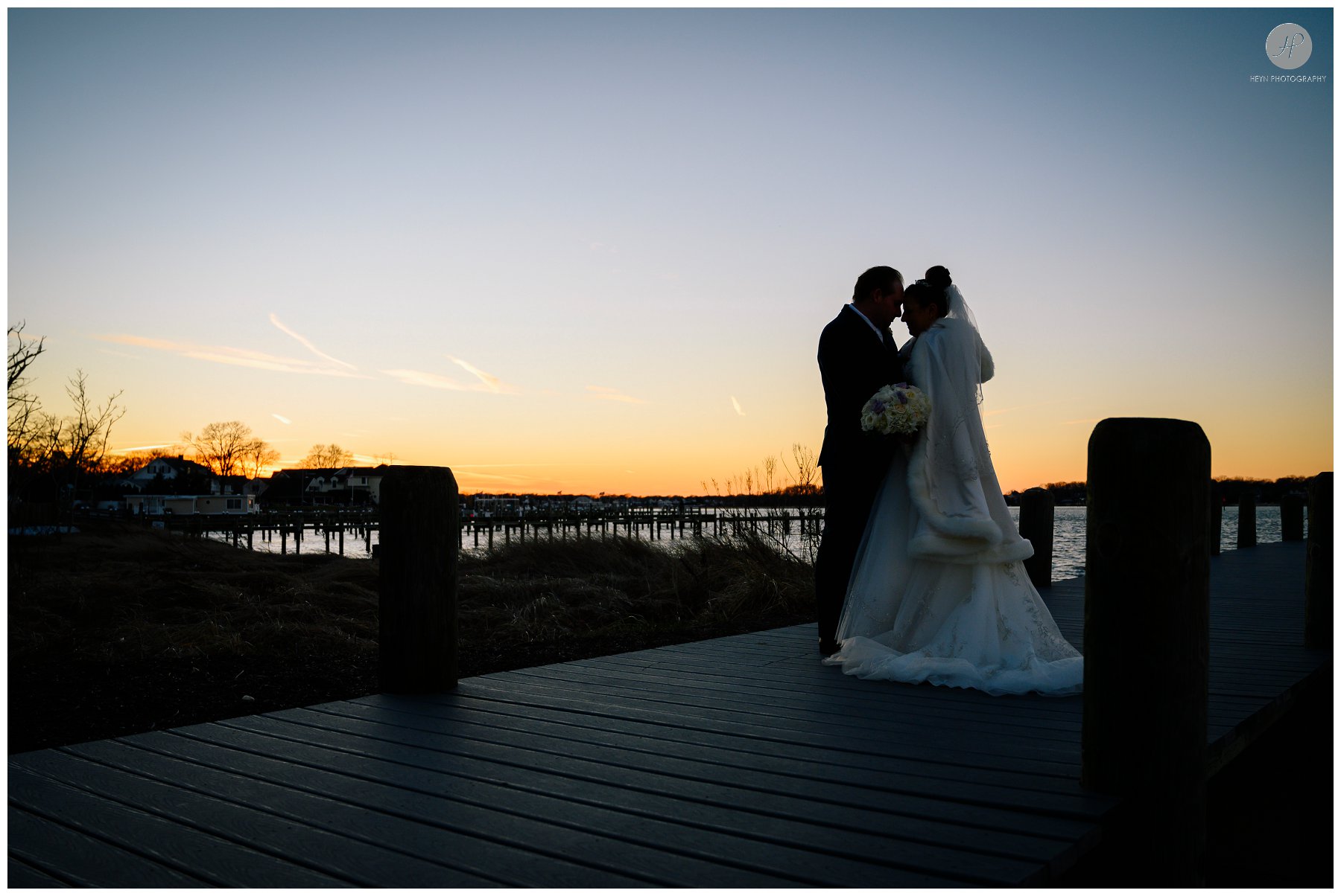 bride and groom at sunset on dock at clarks landing yacht club