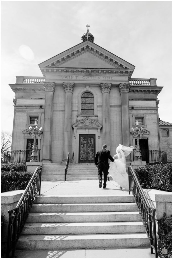 black and white photo of bride and father walking up to church