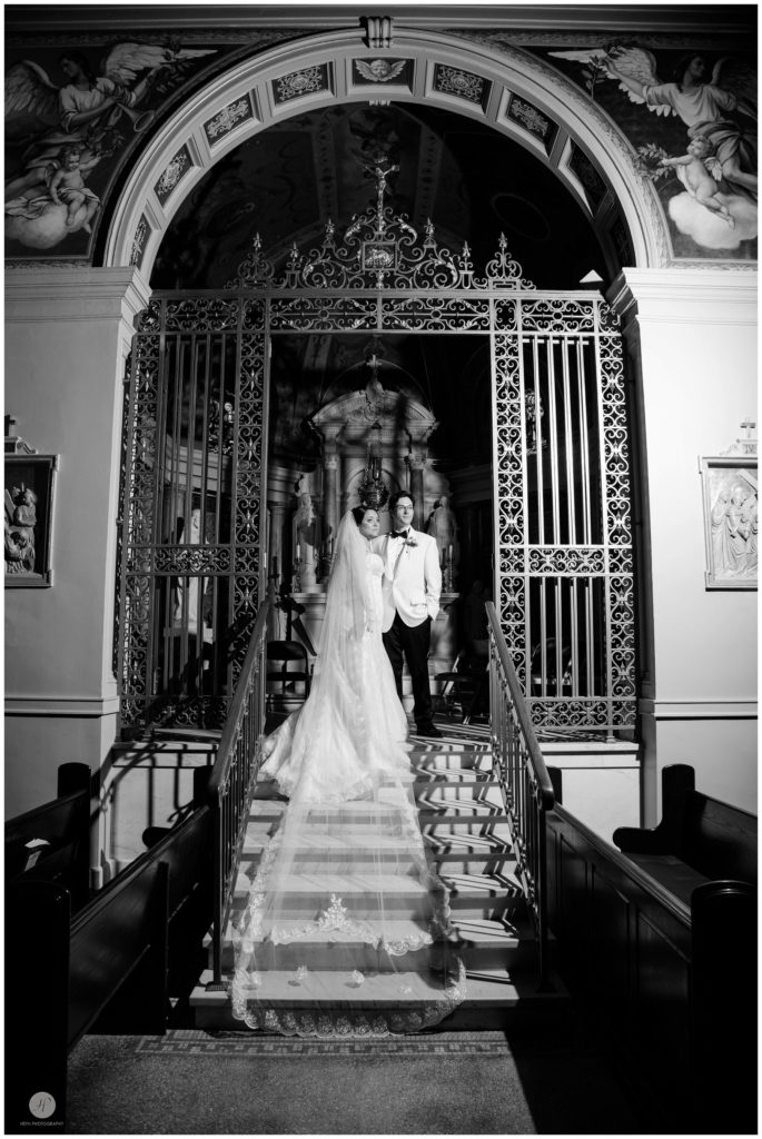 romantic dramatic photo of bride and groom inside cathedral