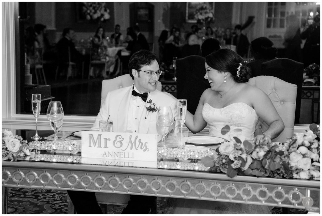 black and white photo of bride and groom at head table