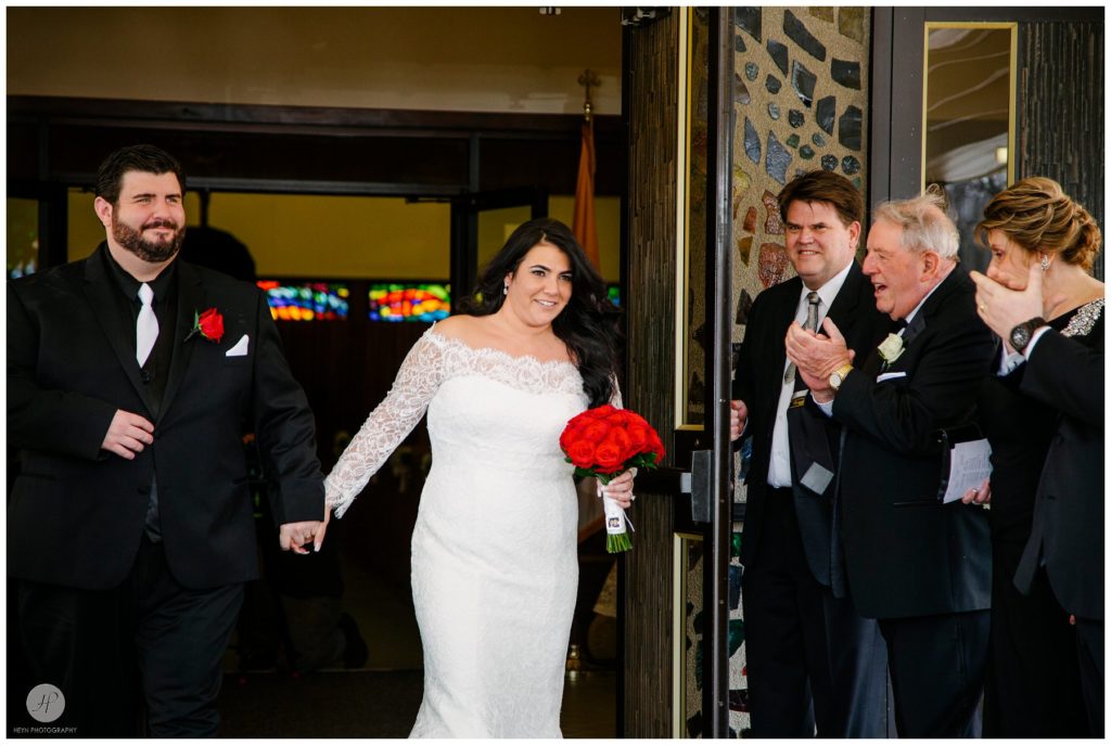 bride and groom walk out photo