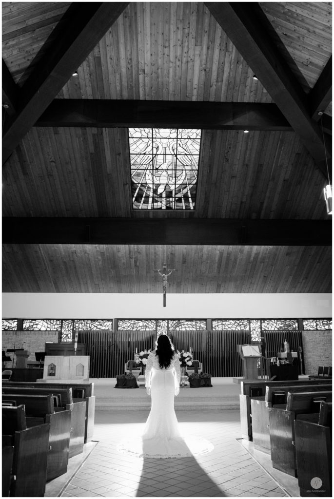 black and white dramatic photo of bride in church